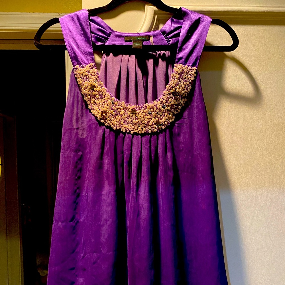Intricate pearl beading on dressy purple blouse